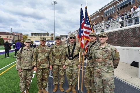 Color guard presents at a Capital football game